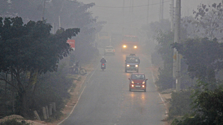 The car lights up in the foggy morning of Late Autumn in the cold weather